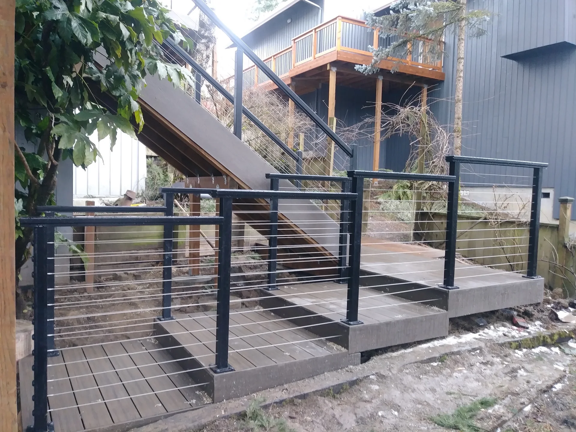 Multi-level deck and stairs with black cable railing