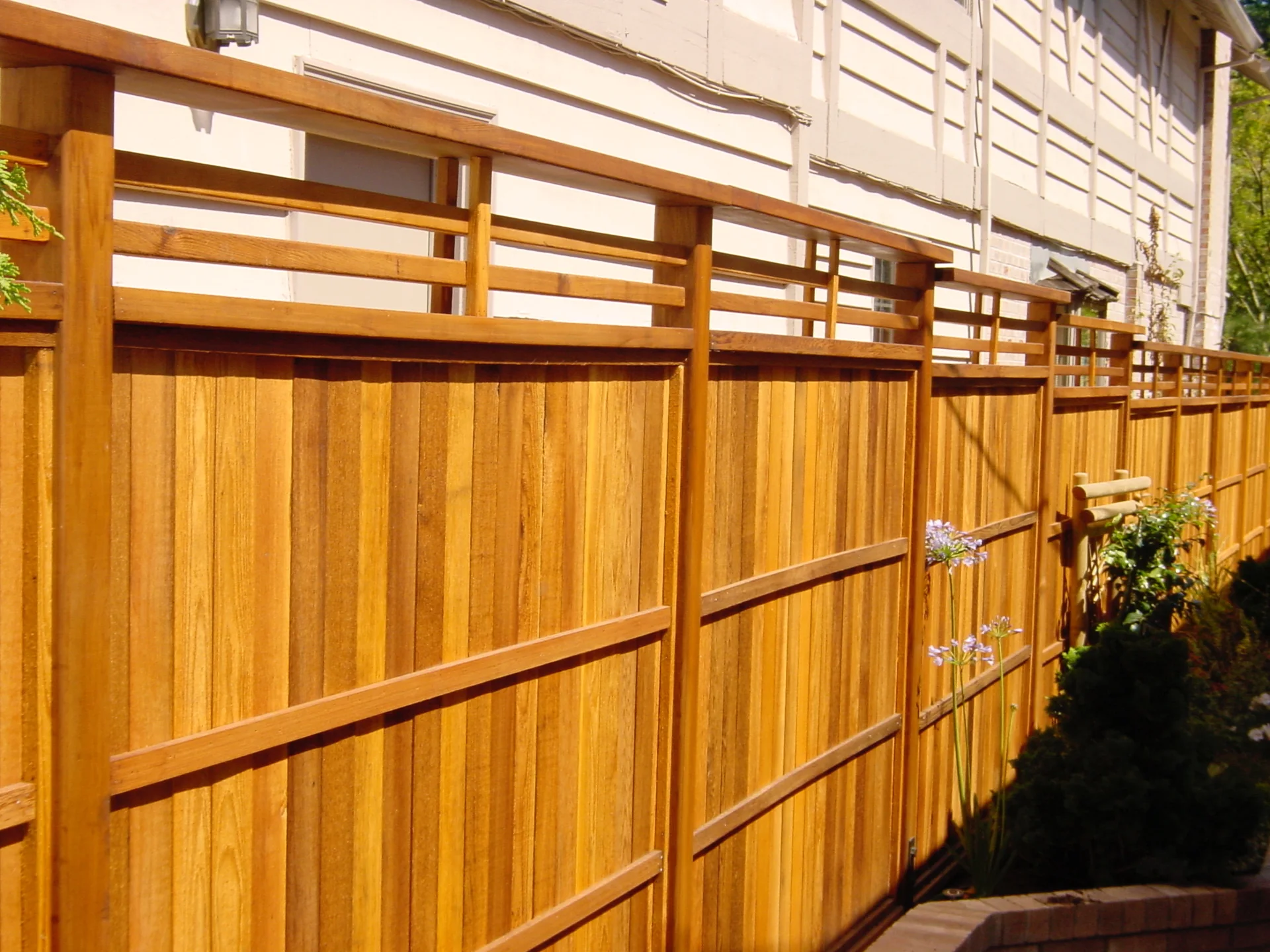 Custom cedar privacy fence with horizontal lattice detailing